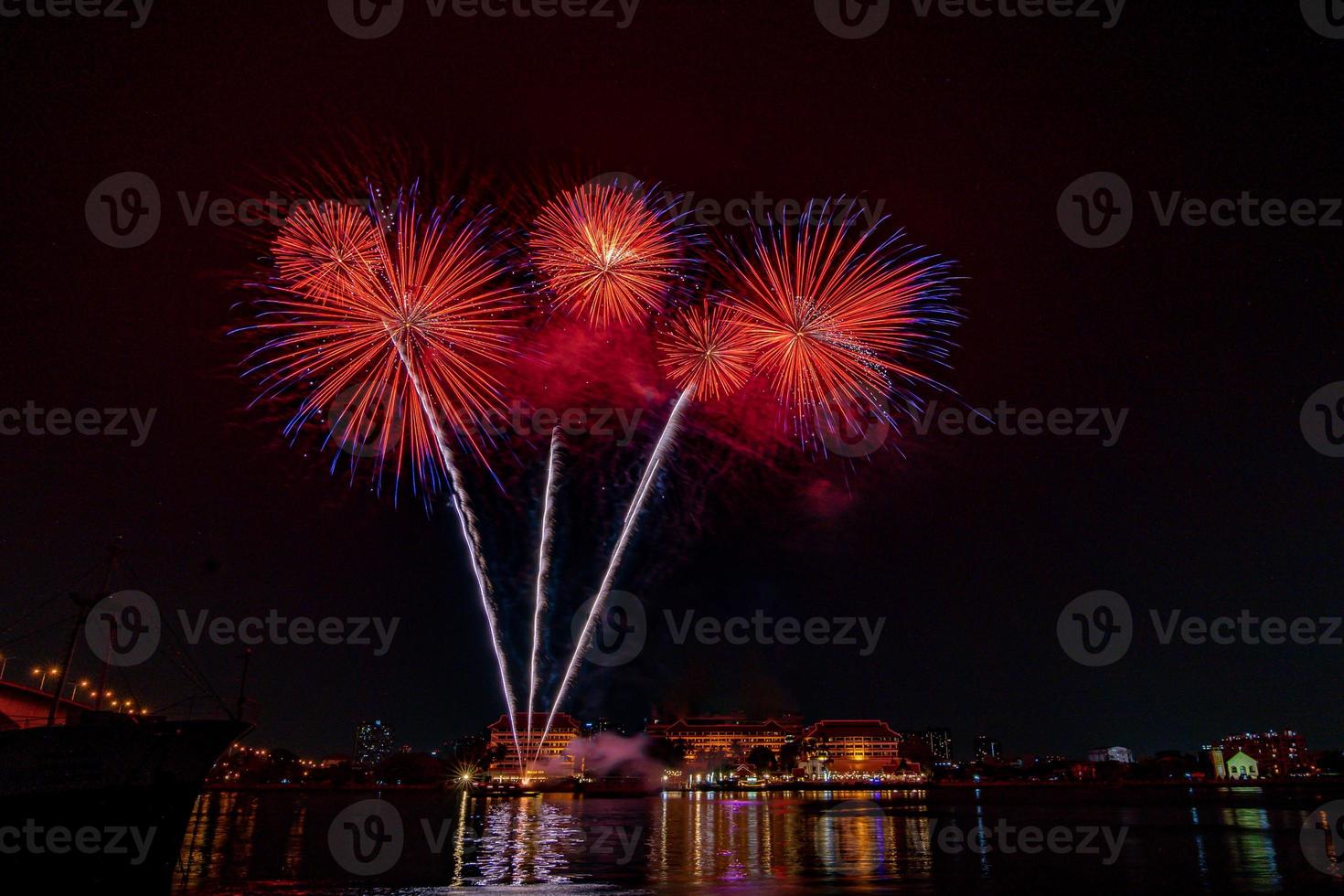 fireworks on the river in the dark sky photo
