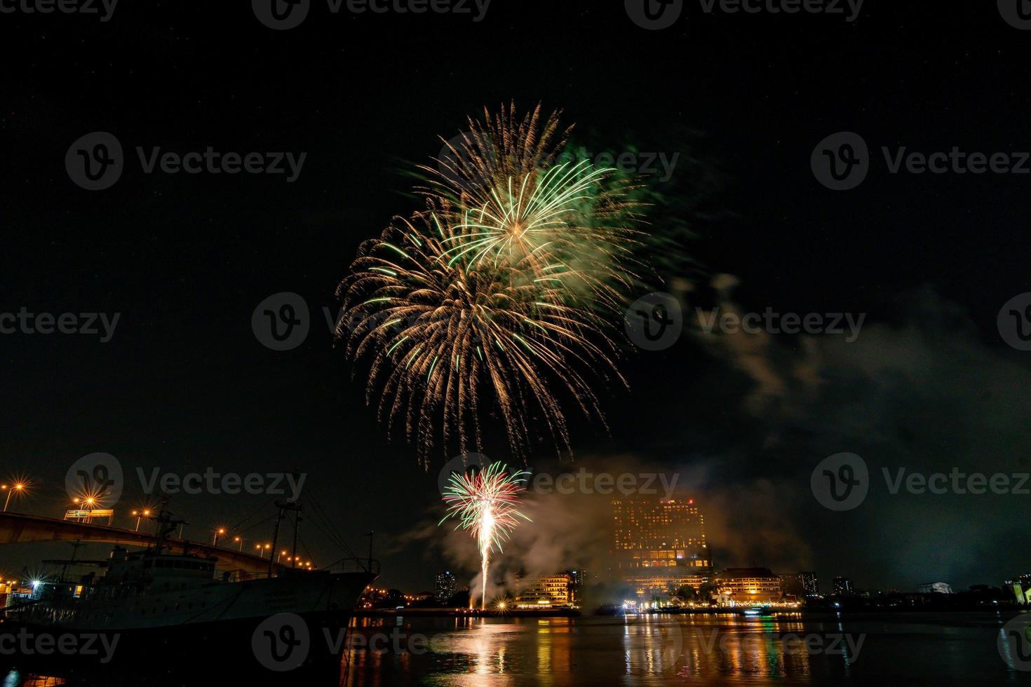 fireworks on the river in the dark sky photo