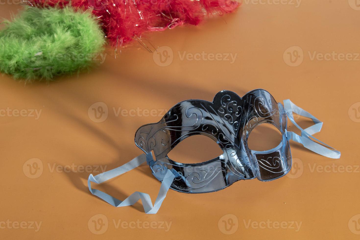 Venetian carnival mask, forming frame in one of the lower corners with space for text photo