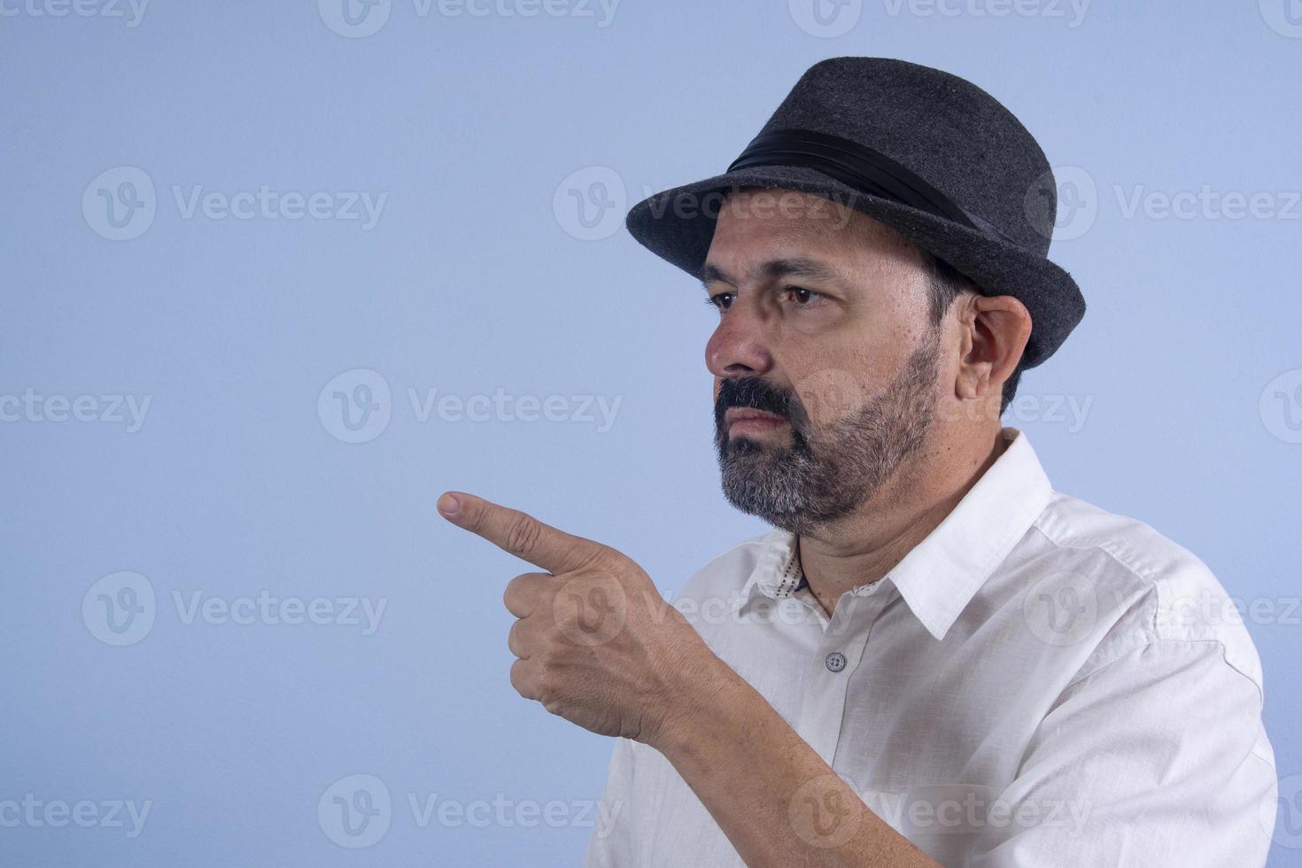 Portrait of 60 years old bearded man on blue background photo