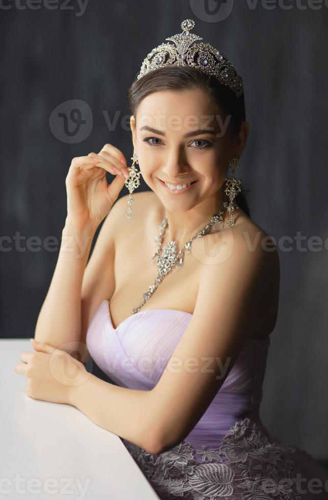 Attractive lady posing in a studio near the table photo