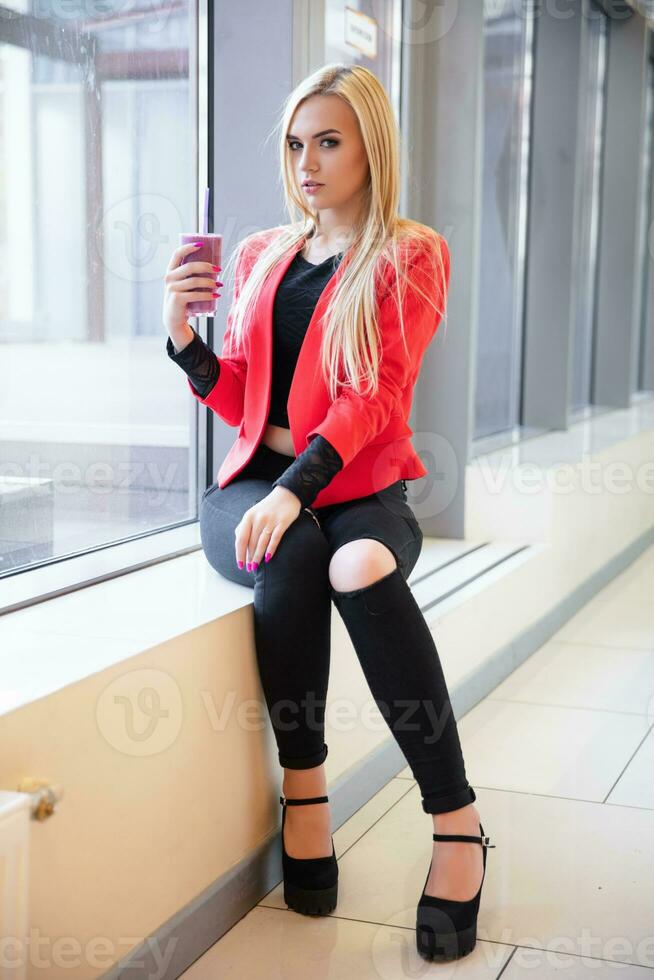 Charming young lady posing at the window photo