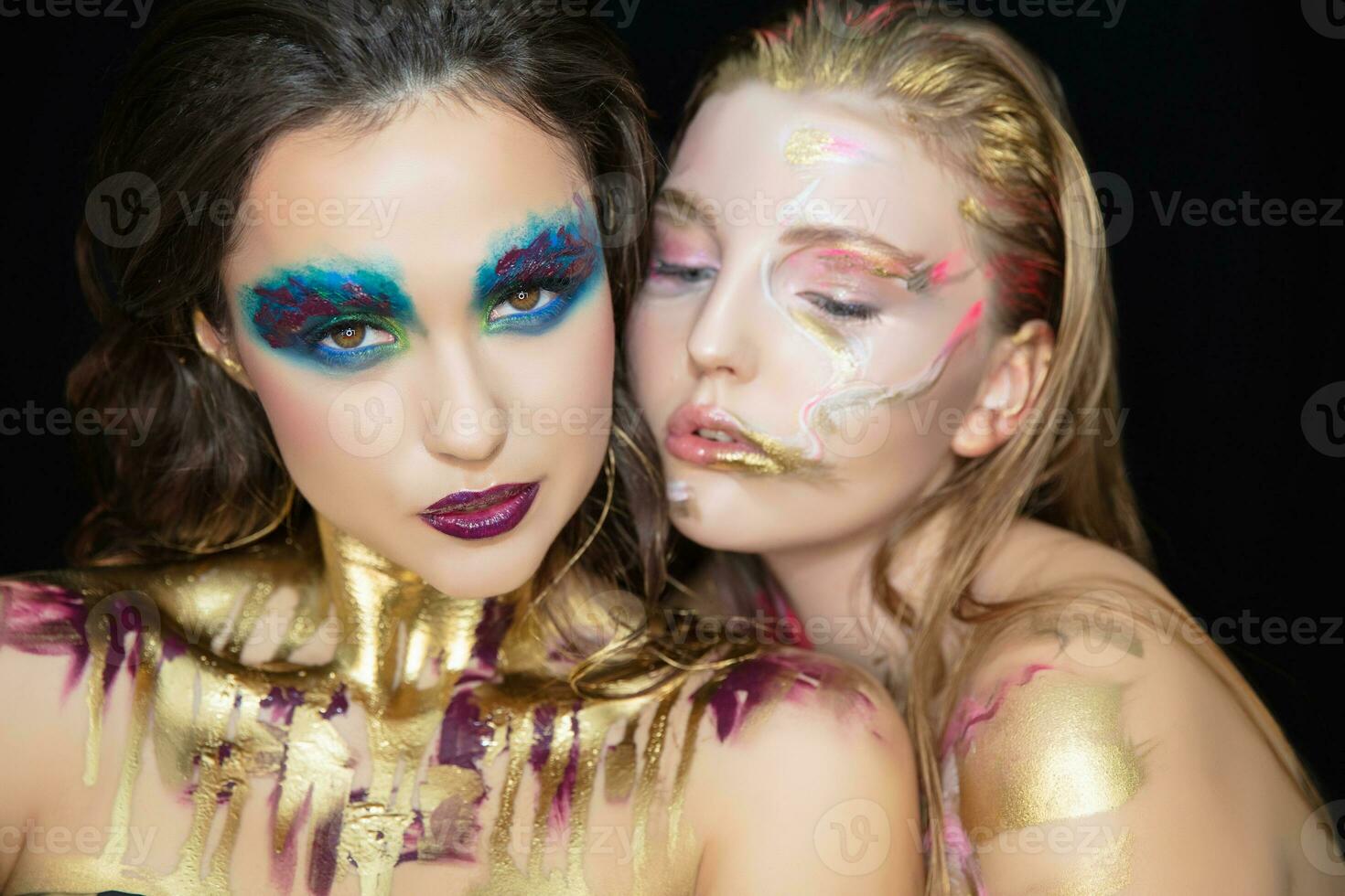 Two cute young women with creative make-up photo