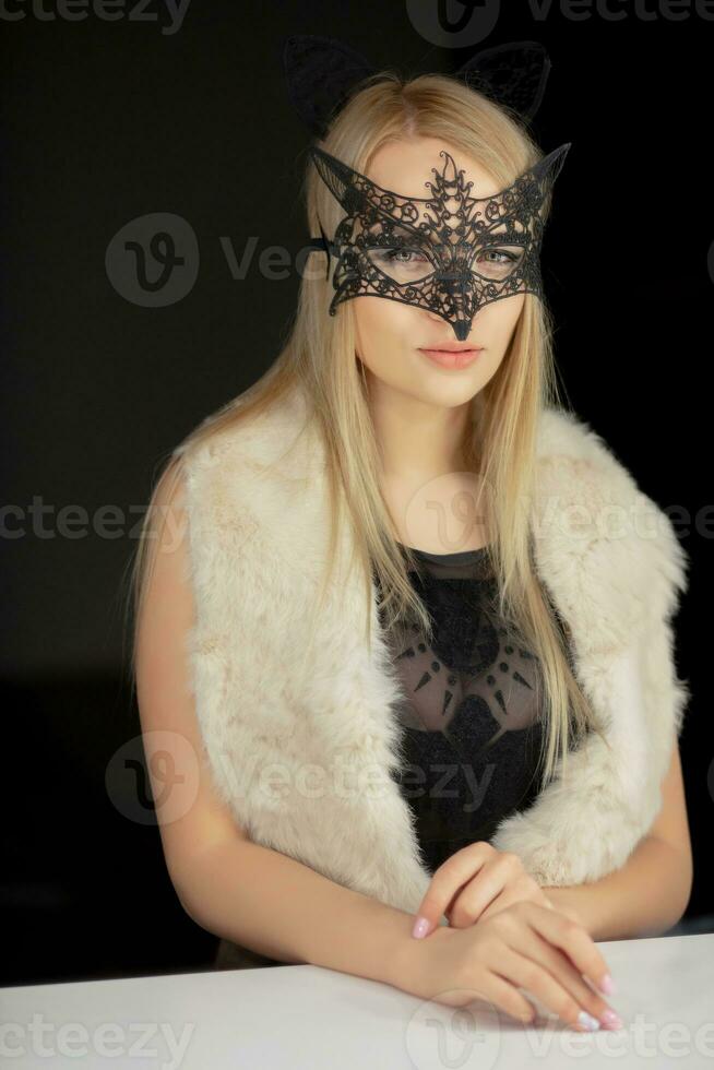 Pretty young woman in a mask photo