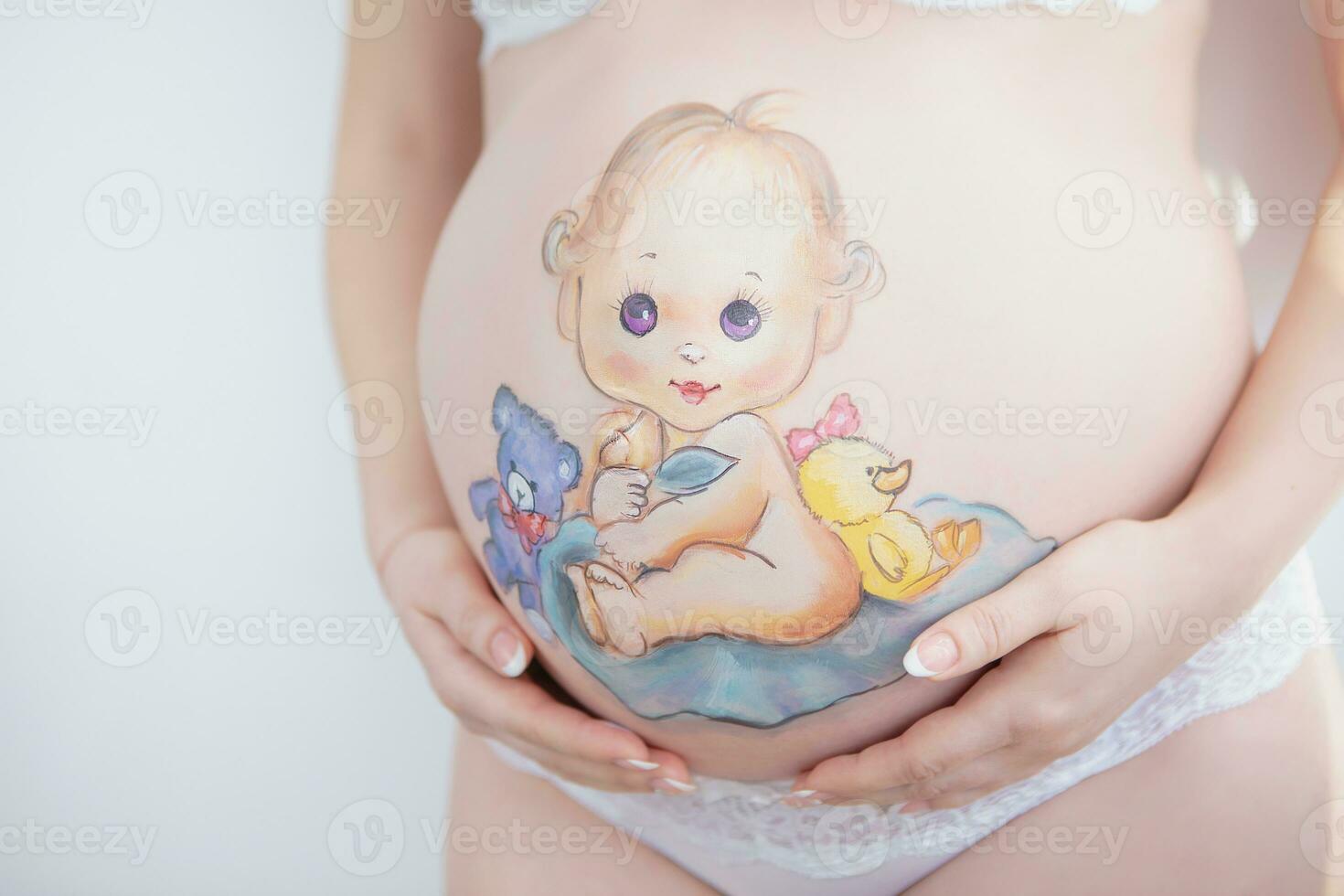 Lovely drawing on the stomach of a pregnant woman photo