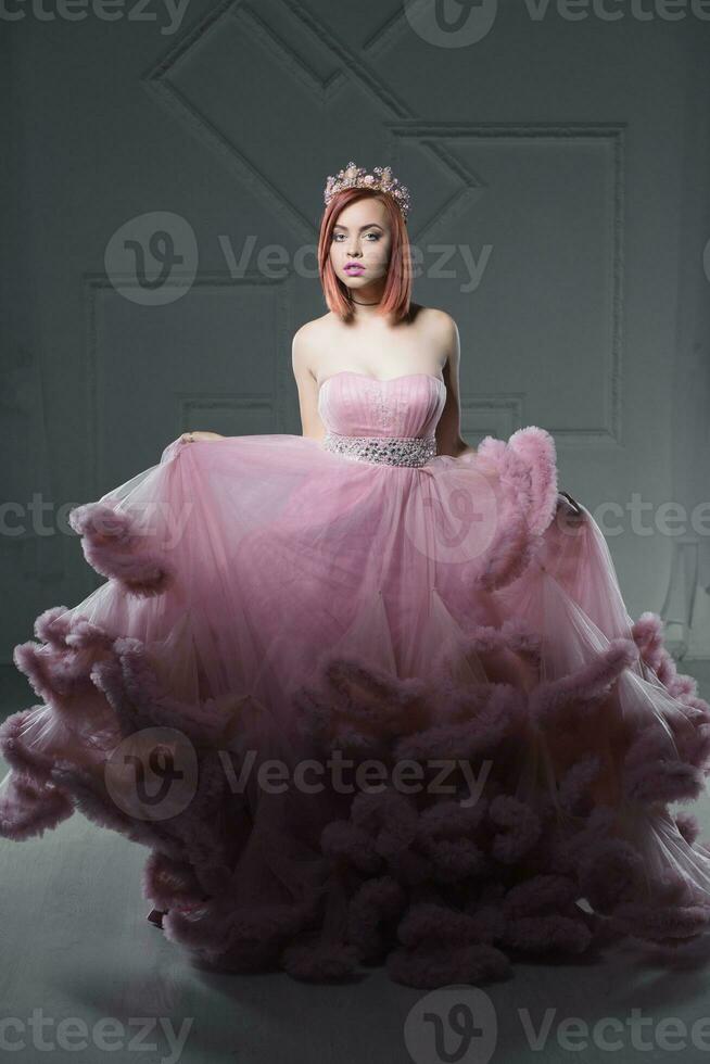 Lovely young redhead woman posing in a studio photo