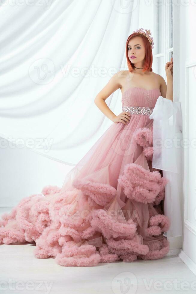 Adorable young redhead woman posing in a studio photo