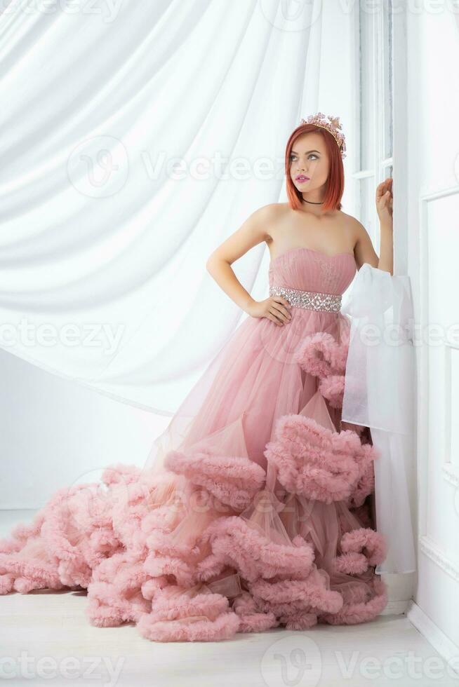 Pretty young redhead woman posing in a studio photo