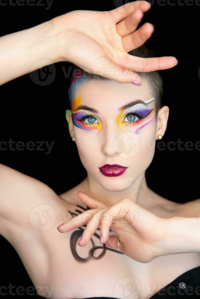 Young beautiful brunette with creative make up photo