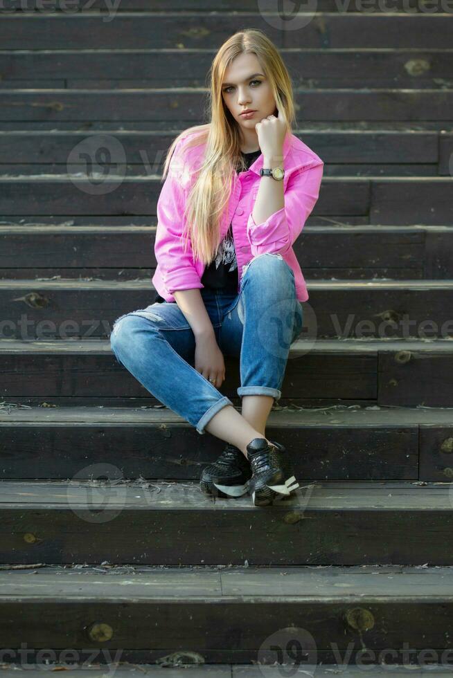 Pensive blonde posing outdoors photo