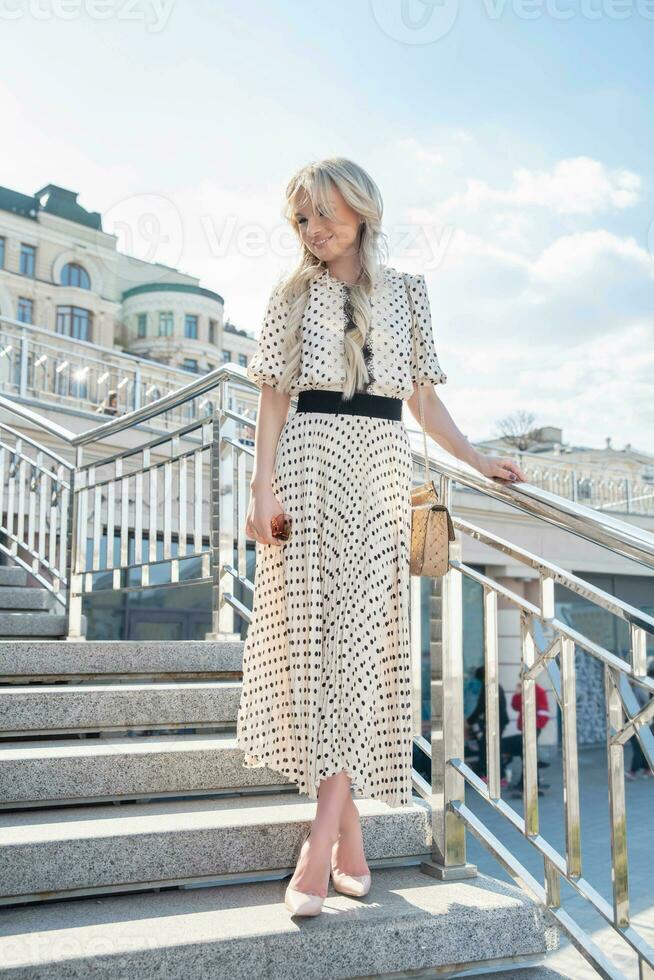 Pretty young woman wearing a long dress photo