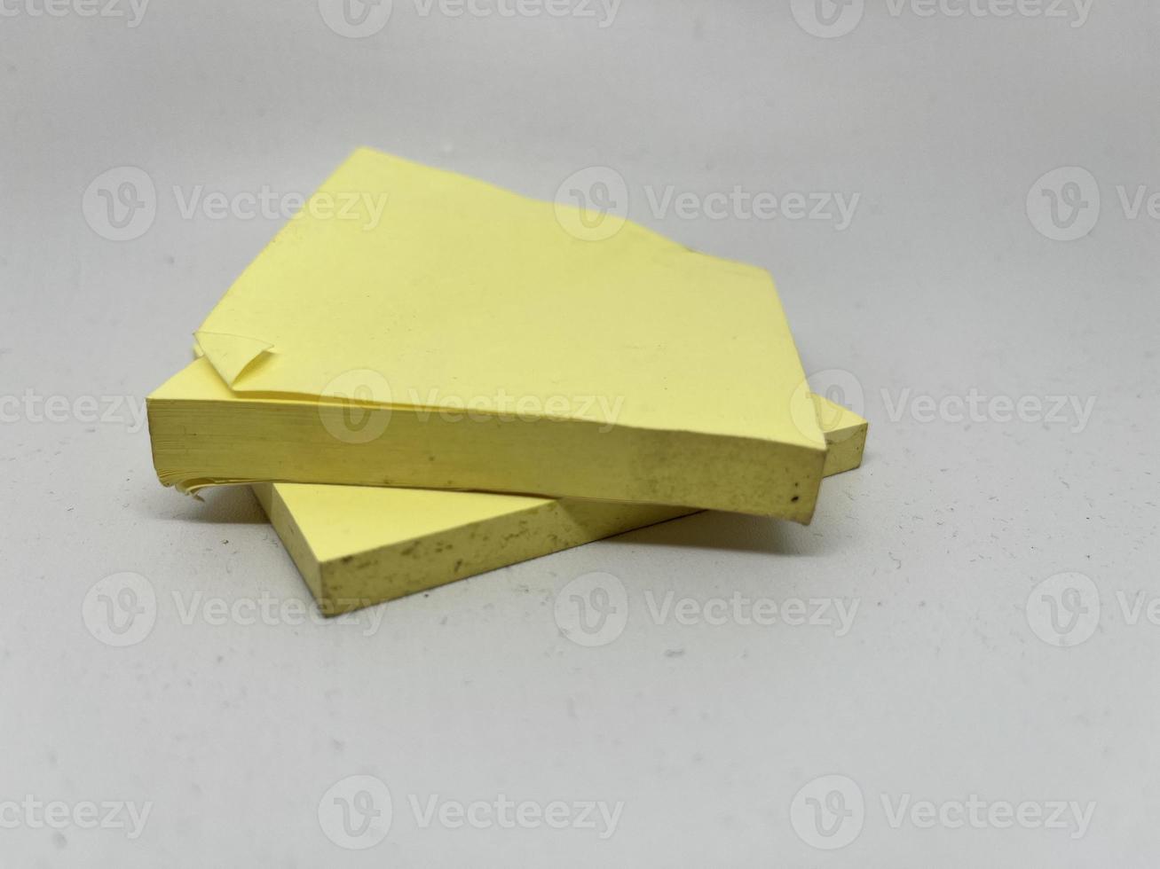 Yellow sticky note block on gray background photo