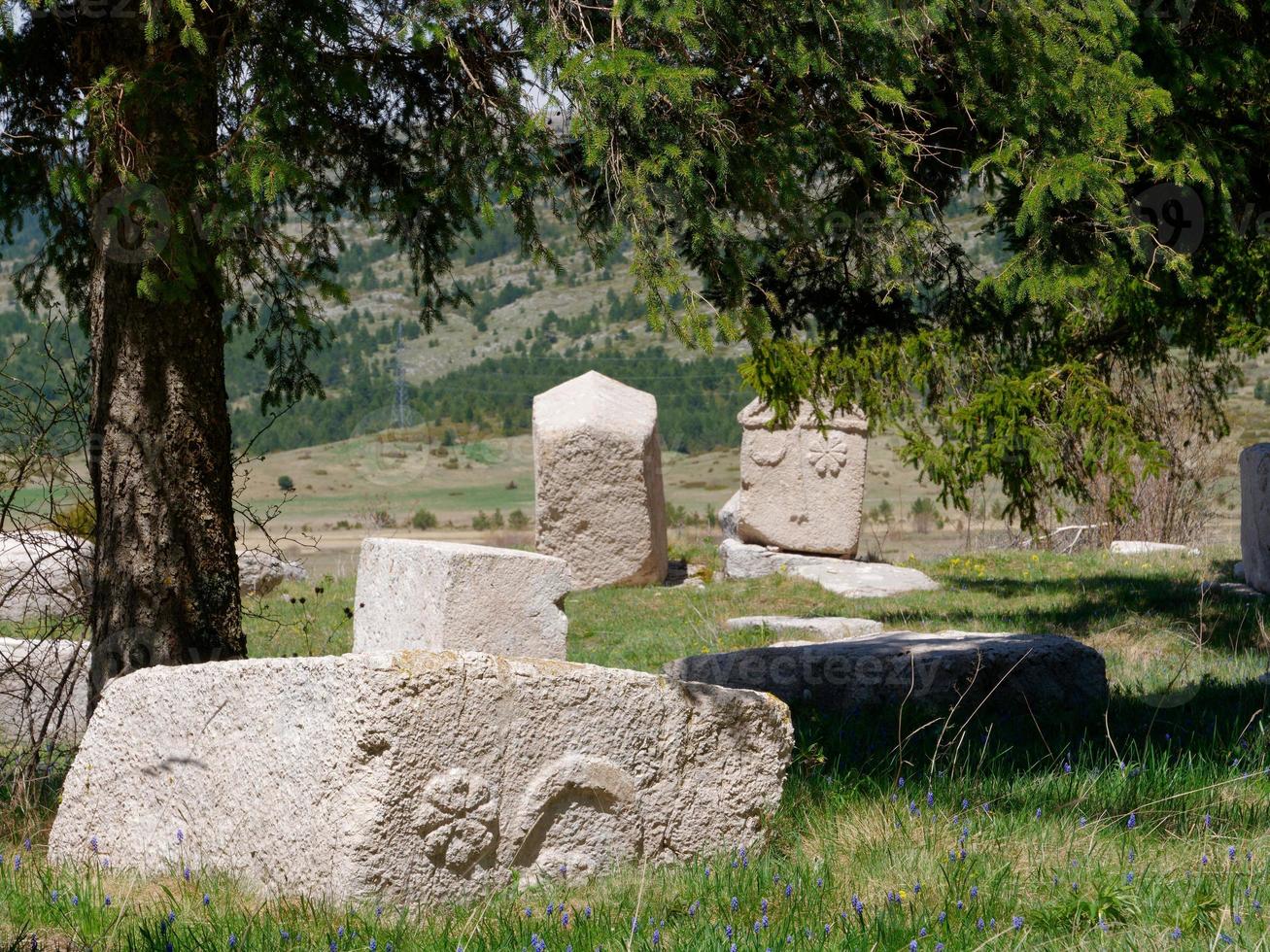 Stecci Medieval Tombstones Graveyards Risovac in Blidinje, BiH. Unesco site. Historic place of interest. The tombstones feature a wide range of decorative motifs and inscriptions. photo