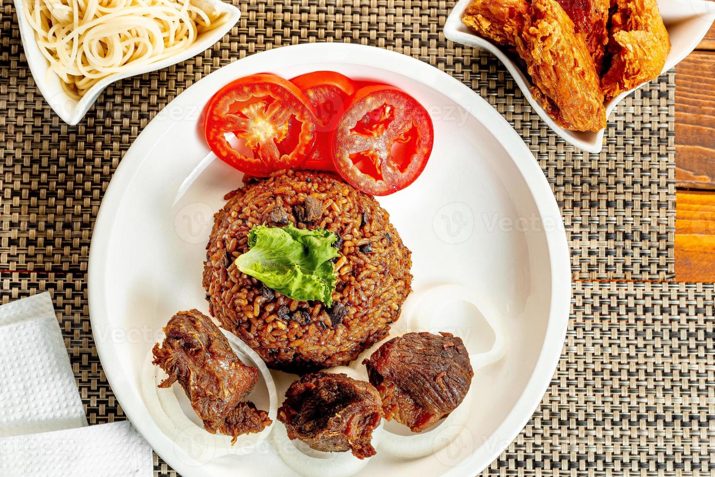 jollof rice with mean - vegetable and fruits photo