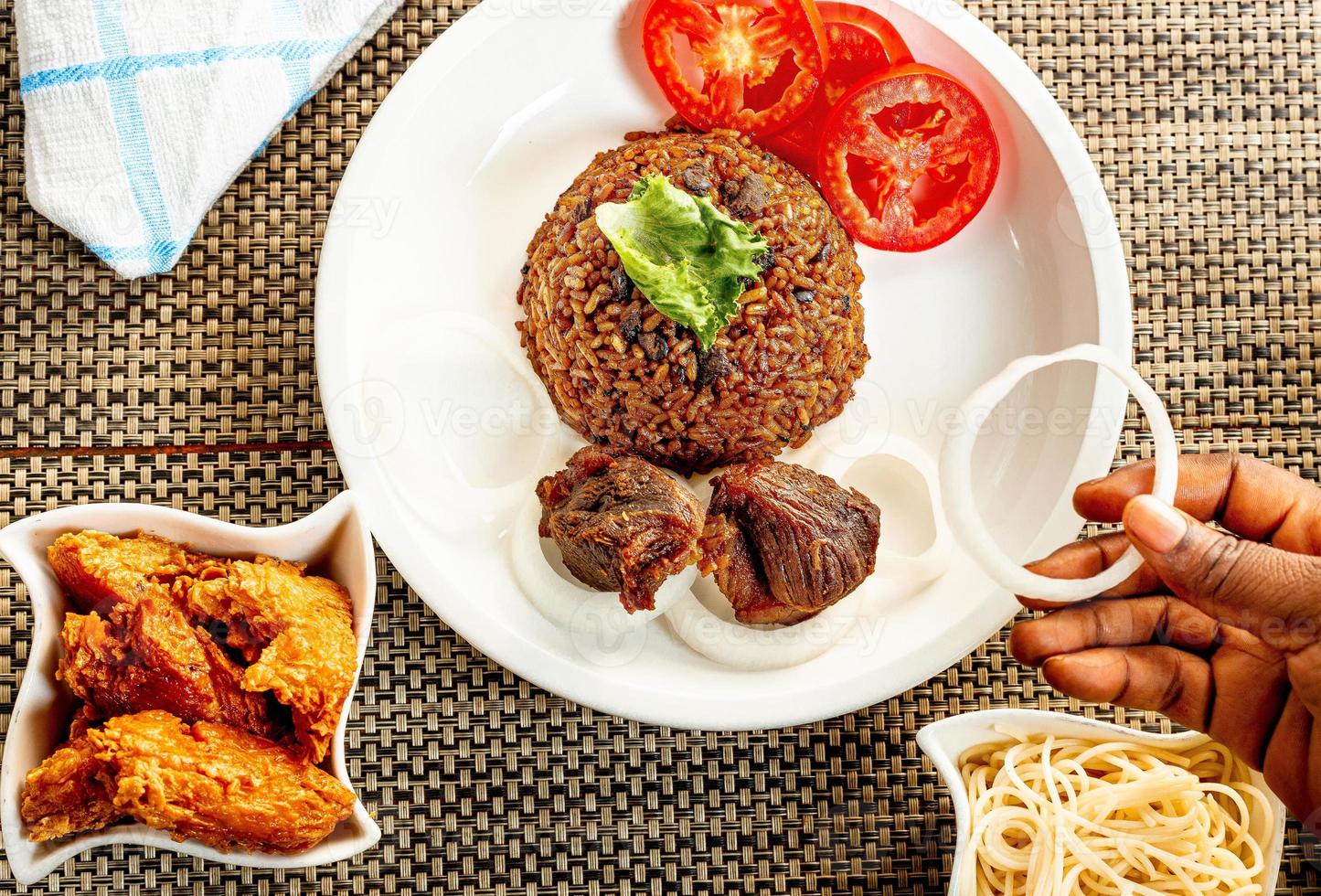 jollof rice with mean - vegetable and fruits photo