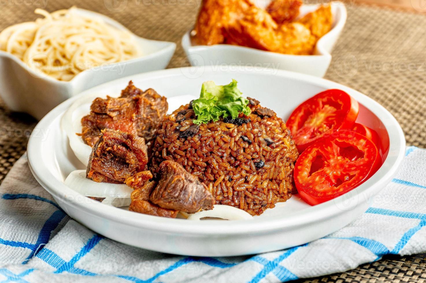 jollof rice with meat - vegetable and fruits photo