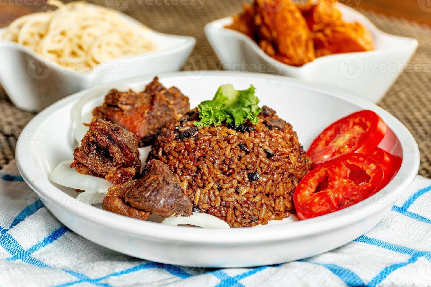 jollof rice with mean - vegetable and fruits photo