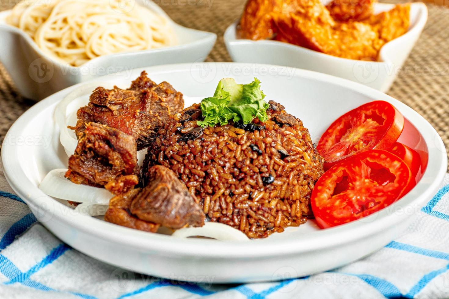 jollof rice with meat - vegetable and fruits photo