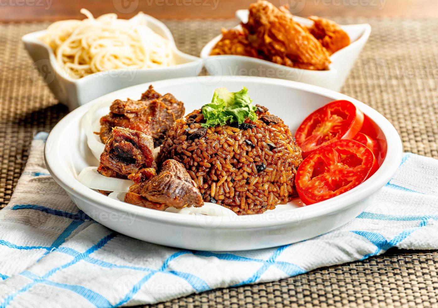 jollof rice with mean - vegetable and fruits photo