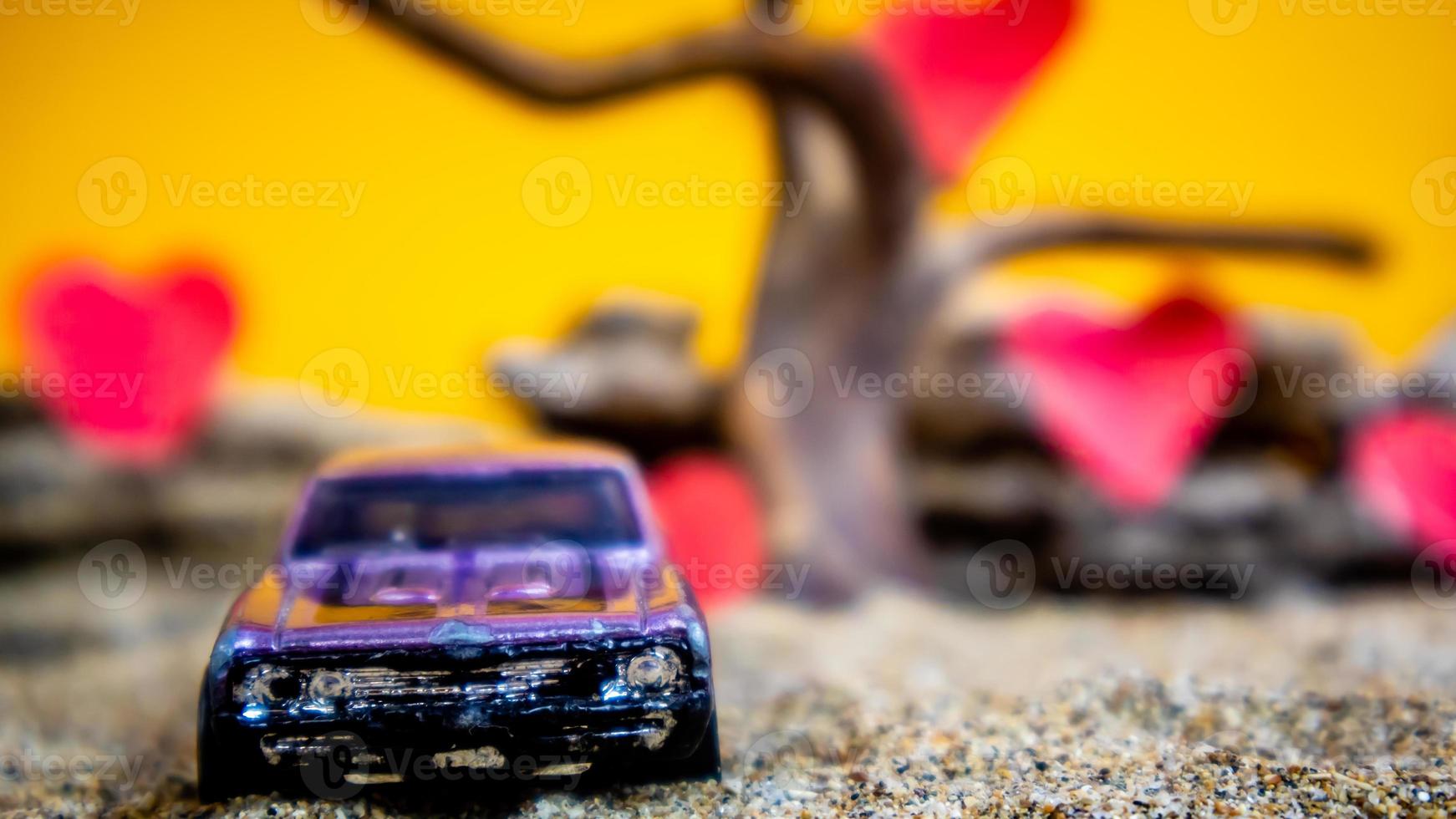 Minahasa, Indonesia  December 2022, toy car with gradient orange background and a heart photo