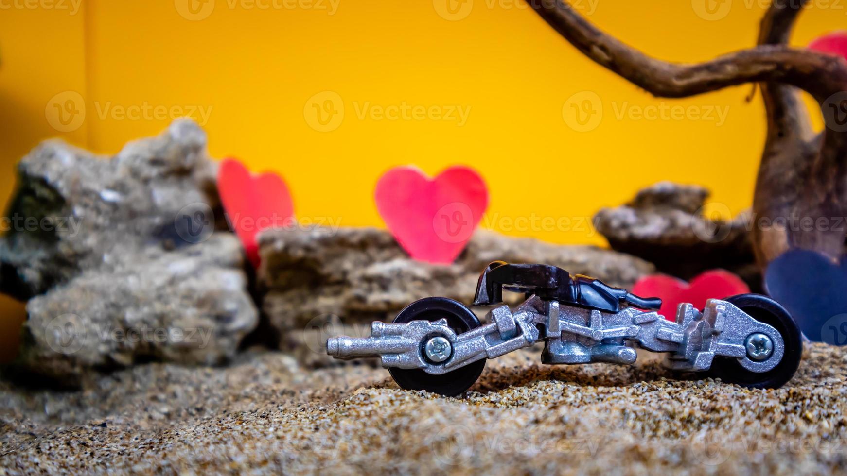 Minahasa, Indonesia  December 2022, toy car with gradient orange background and a heart photo