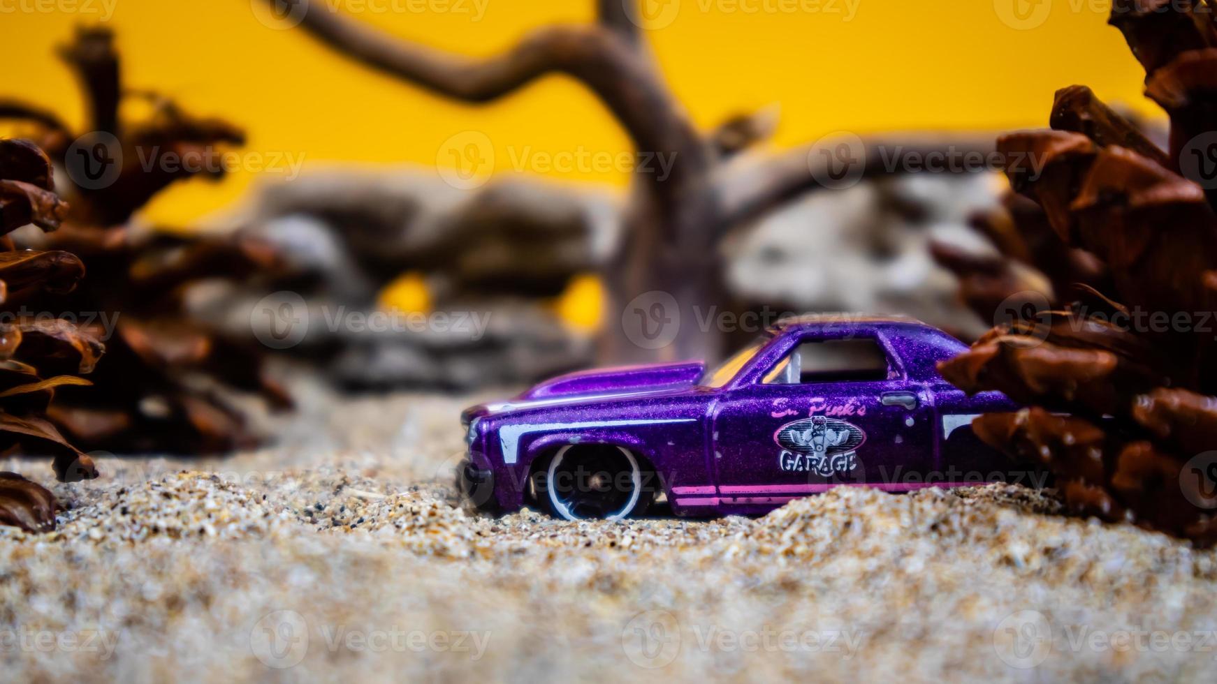 Minahasa, Indonesia  saturday, December 2022, a toy car among the pinecones photo