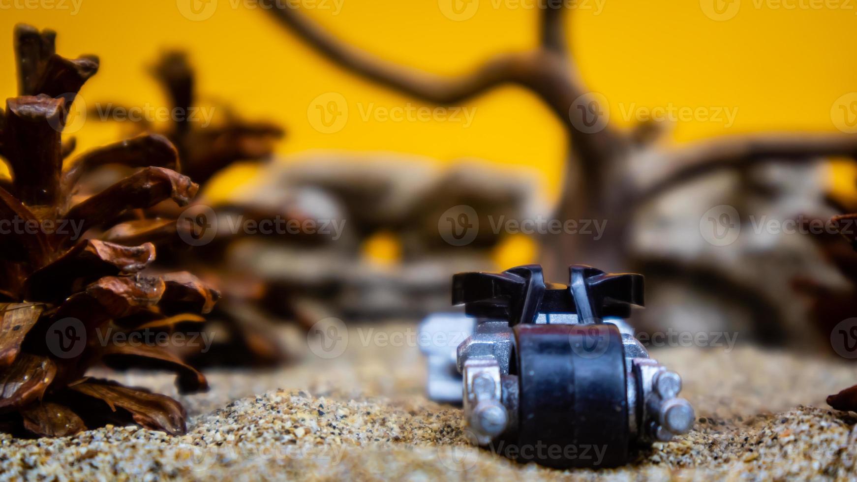 Minahasa, Indonesia saturday, December 2022, a toy car among the pinecones photo