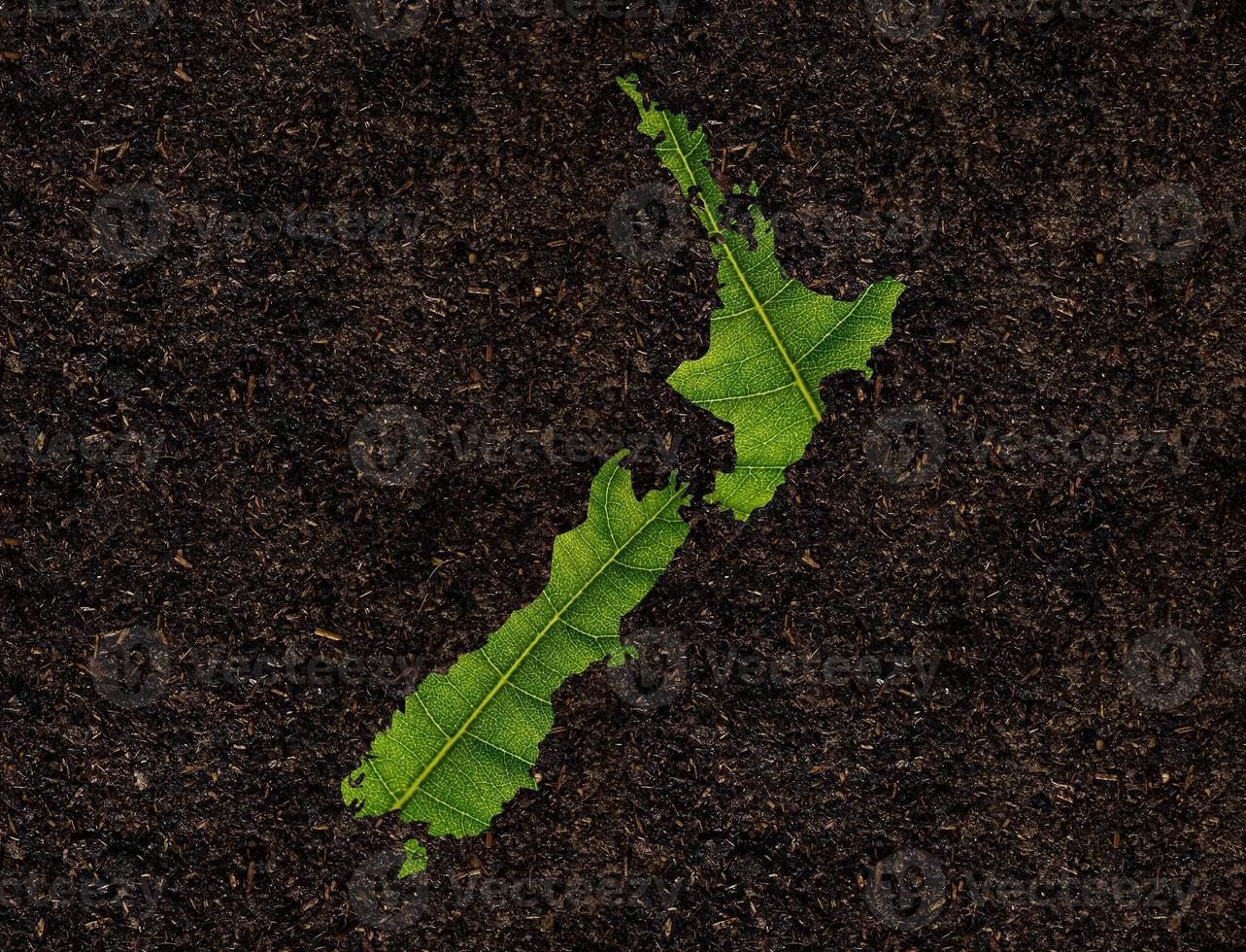 New Zealand map made of green leaves on soil background ecology concept photo