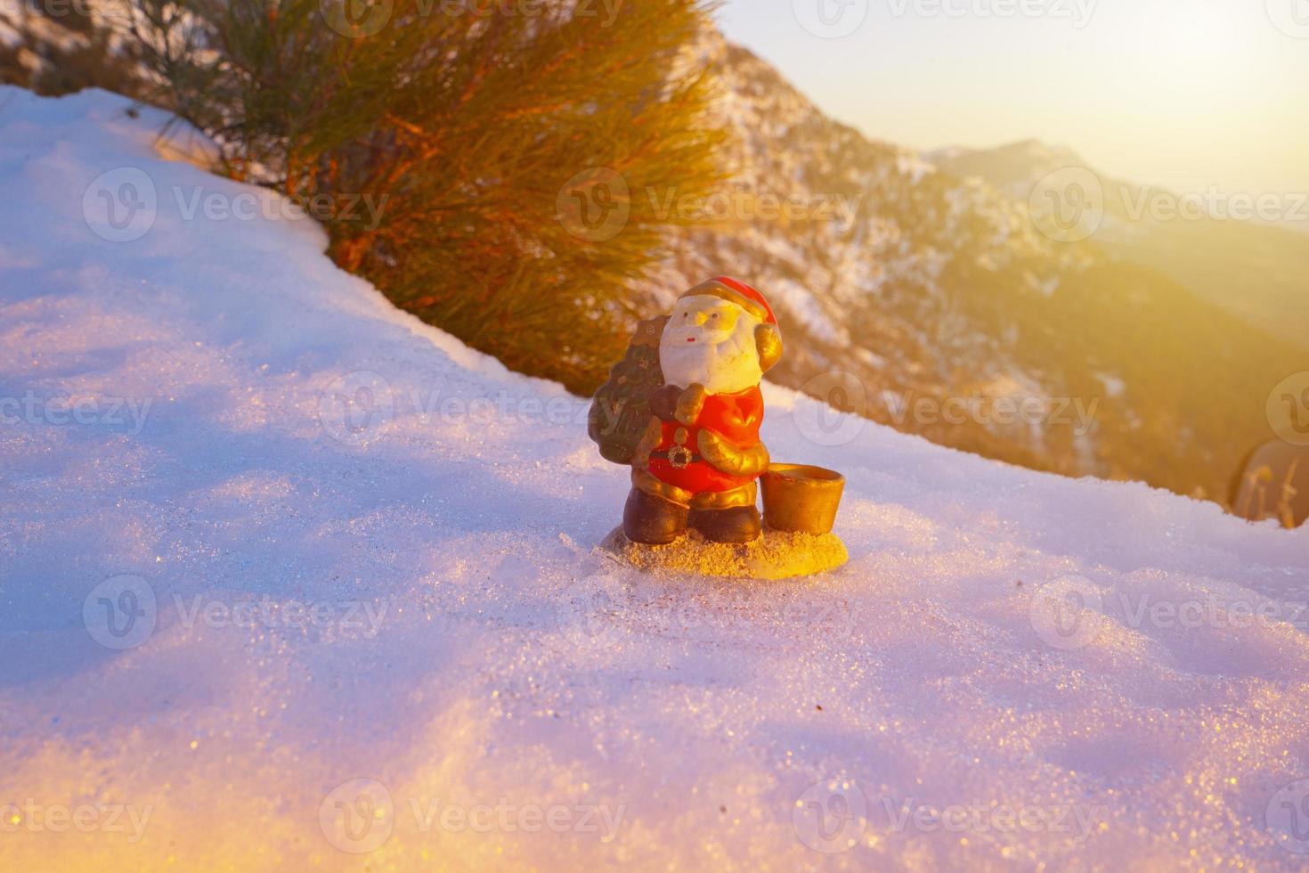 santa lies in the snow on the background of christmas treeswinter background selective focus photo