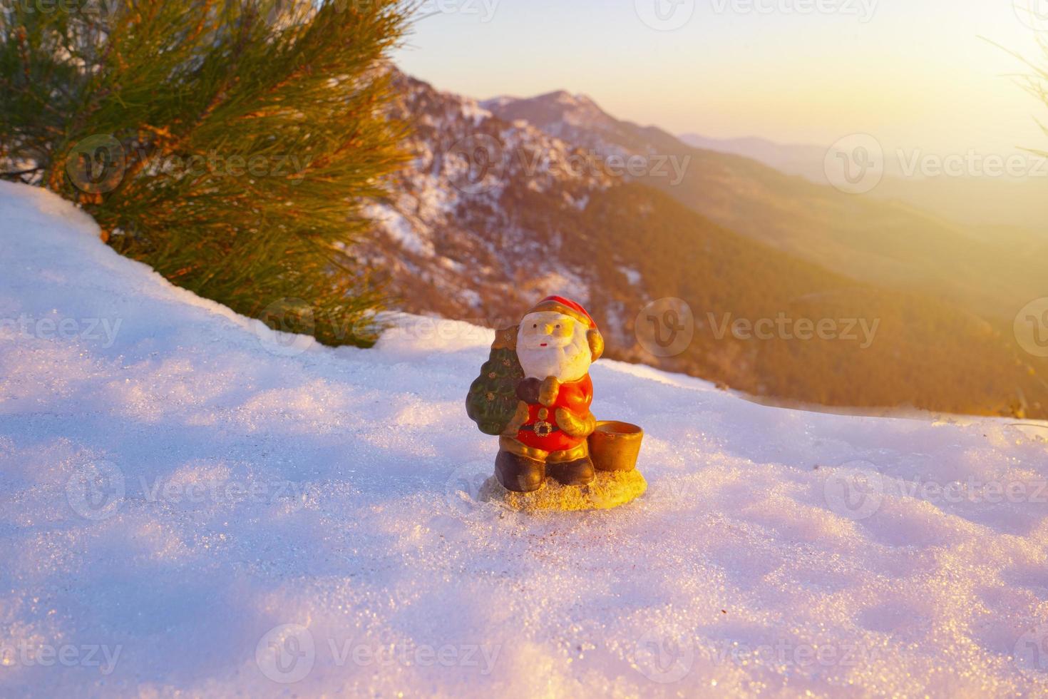 santa lies in the snow on the background of christmas treeswinter background selective focus photo
