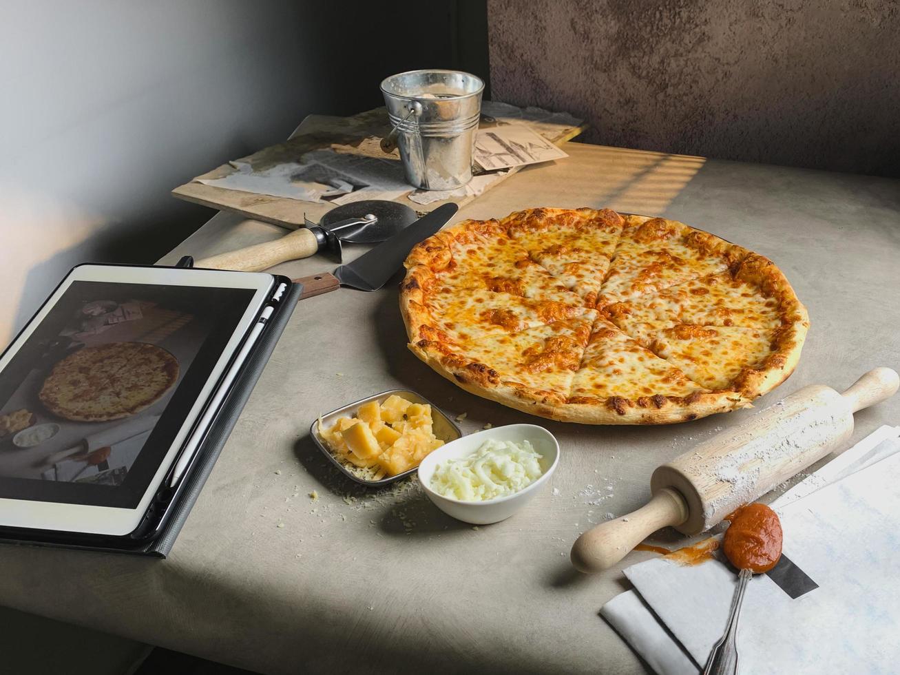 New York style pizza tomato sauce and melted mozzarella cheese on table. photo