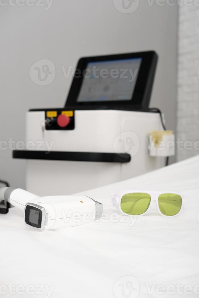 Laser epilation machine in beauty salon. Body care and cosmetology concept, Hair removal apparatus photo