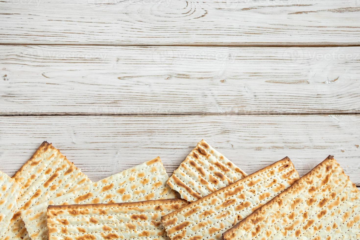 Concept of Jewish holiday Pesach. Passover. Traditional matzah on a white wooden background. Matzo bread. photo