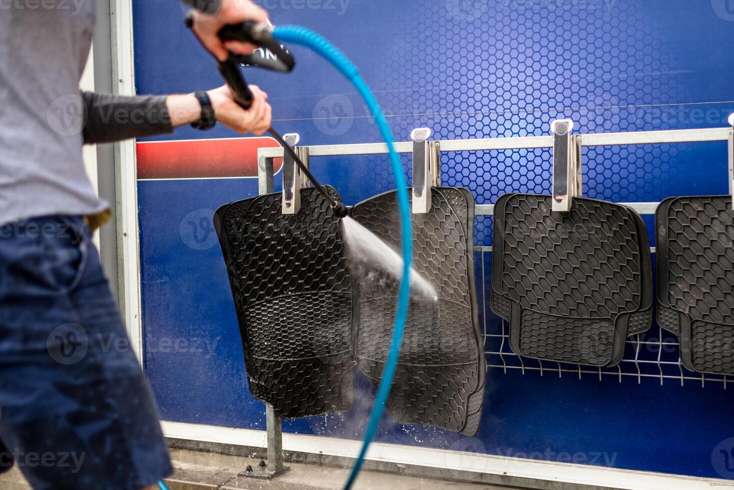 Worker washing car with sponge on a car wash, Manual car wash with white soap, Car wash self