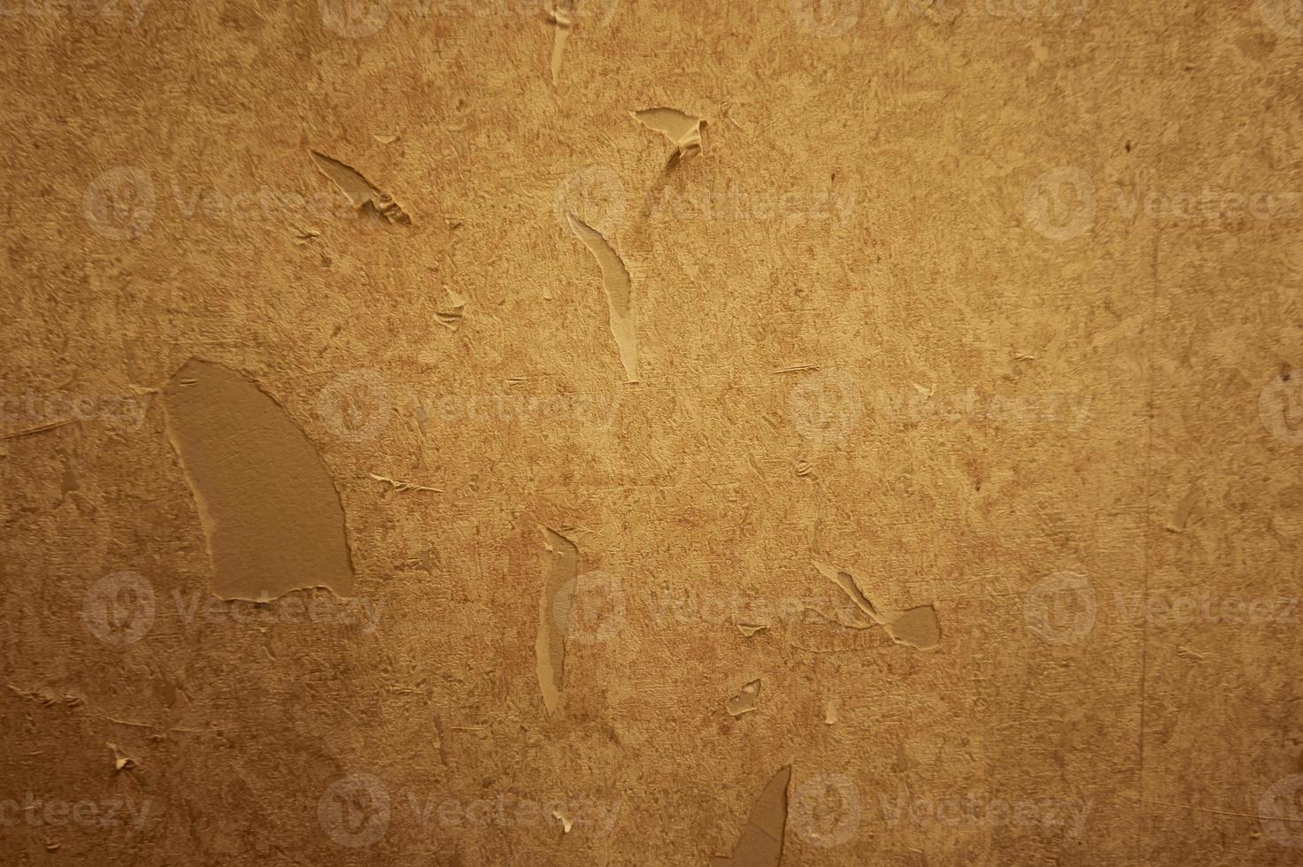 Close up of torn or ripped wallpaper. Hole in the wallpaper on the wall. Old faded floral wallpaper teared down or peeling off walls of the house for general background. Front view close up details. photo