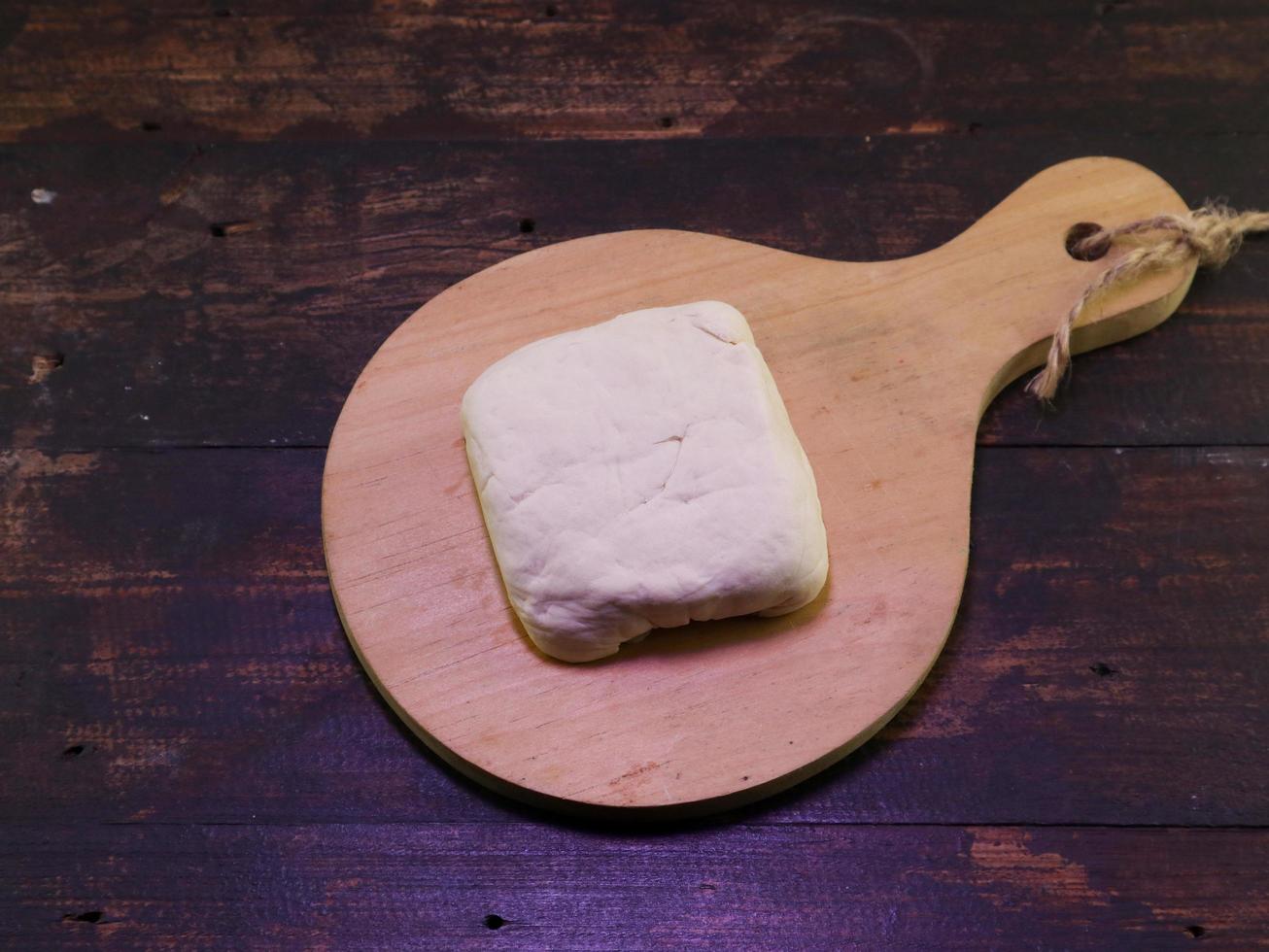 Block of white tofu on a wooden plate photo