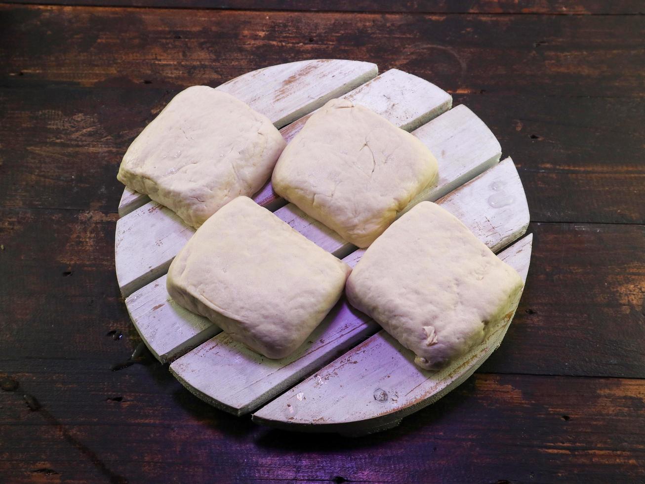 Block of white tofu on a wooden plate photo