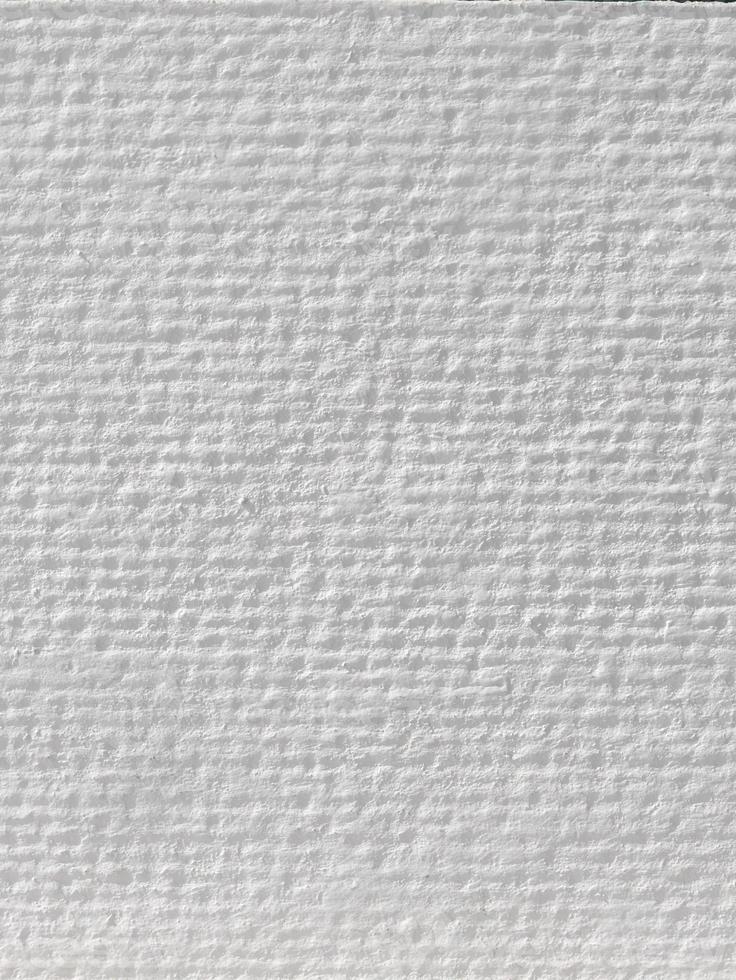 White watercolor paper or wall, wavy rough texture pattern, abstract background, wallpaper, brush stroke graphic, art paper, splashes, copy space for text, vertical photo