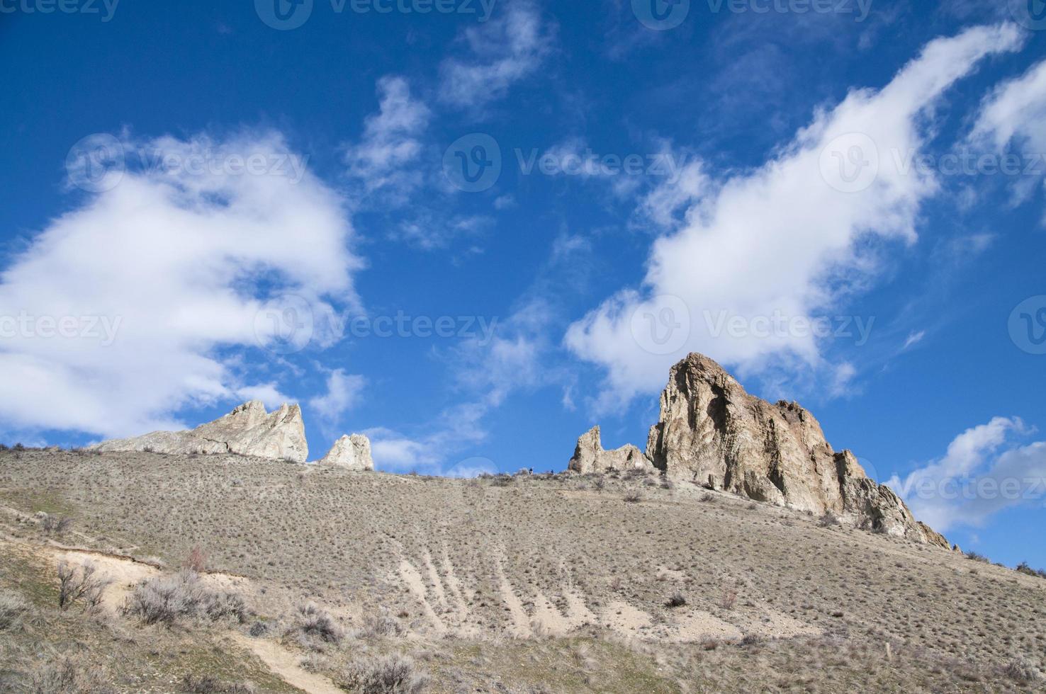 Rocks on the deserted hill under the blue sky photo