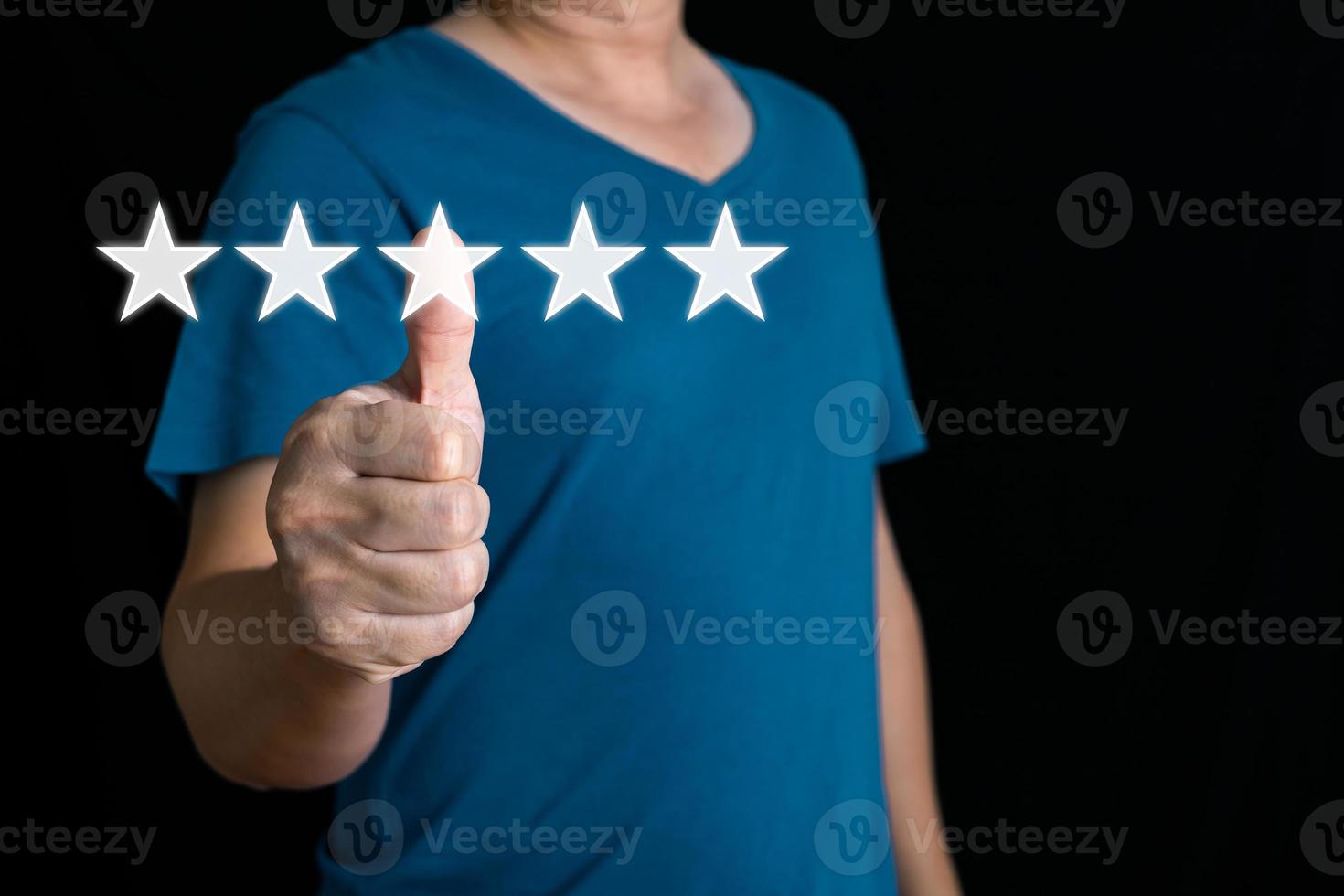 a businessman thumbs up on the five star to give satisfaction in service.rating very impressed.Customer service and Satisfaction concept. photo