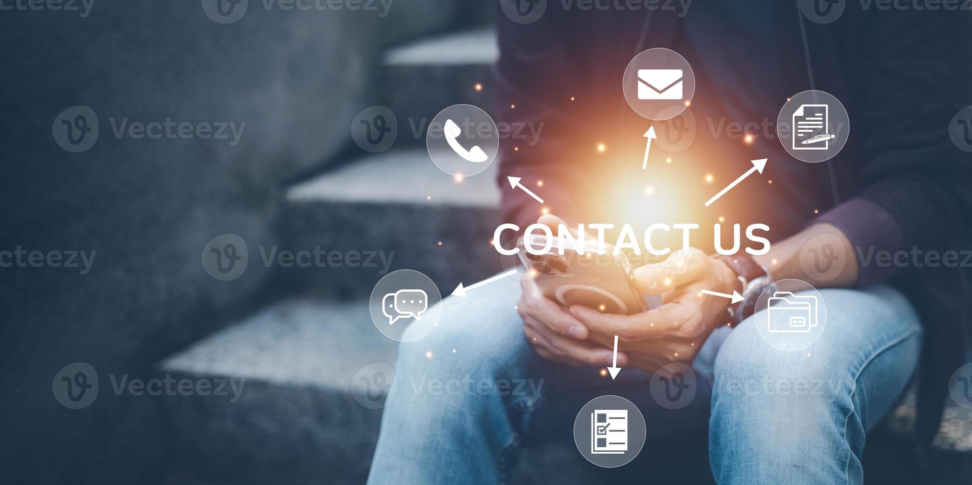 Communication and Contact us or Customer support hotline people connect. Hand using a laptop and touching on virtual screen contact icons, email and address, live chat with internet wifi. photo
