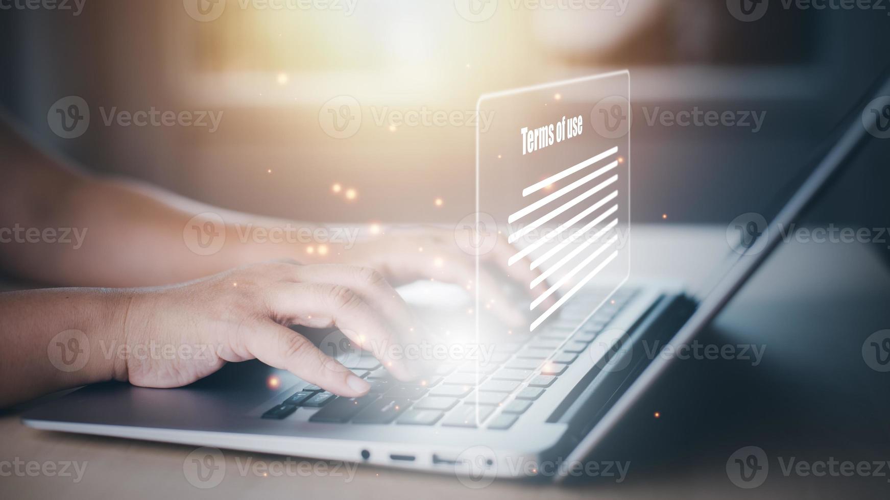 Man using a laptop with a graph of Terms of use concept, online banking check budget planning concept banner for website header design,Terms of use business concept. Terms and conditions of contract. photo