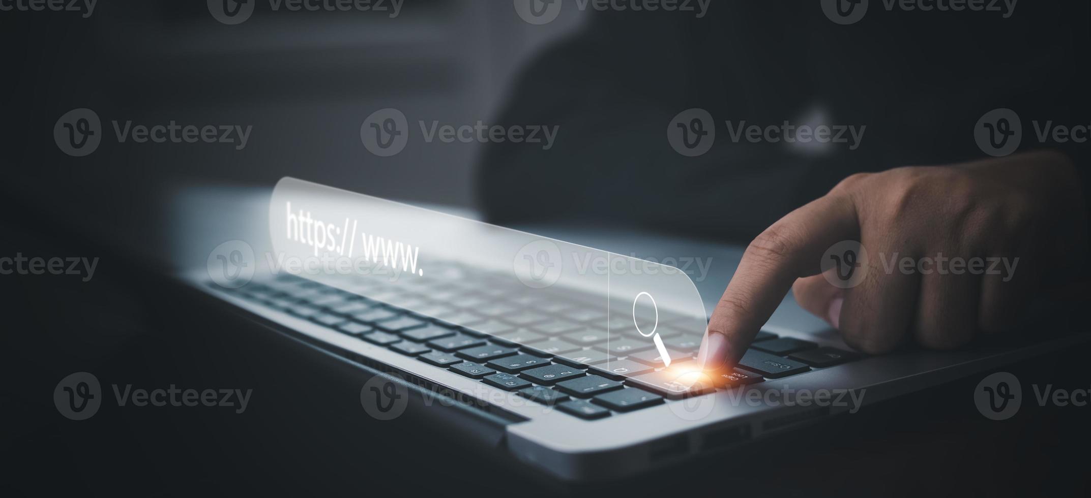 Hand  type laptop and Searching Browsing Internet Data Information with blank search bar. man's hands are using smartphone and keyboard to Searching for information. Using Search Console with website. photo