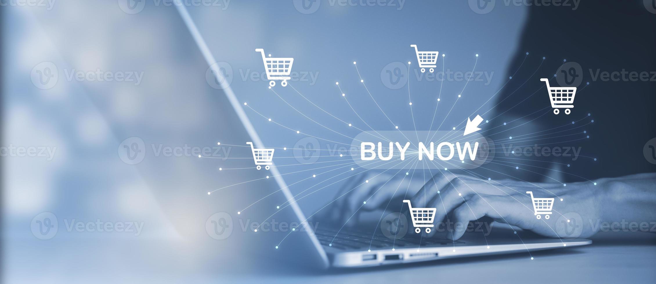 Man using a laptop with typing on a keyboard with online shopping concept, Shopping cart part of the network in hand, Innovation in eCommerce, Online shopping business with selecting shopping cart. photo