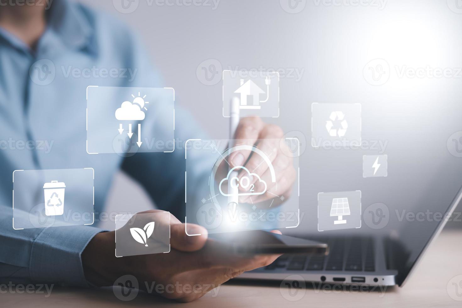 man hold Smartphone and global network connection with virtual modern reduce CO2 emission concept with icons, global warming emissions carbon footprint climate change to limit global warming, energy photo