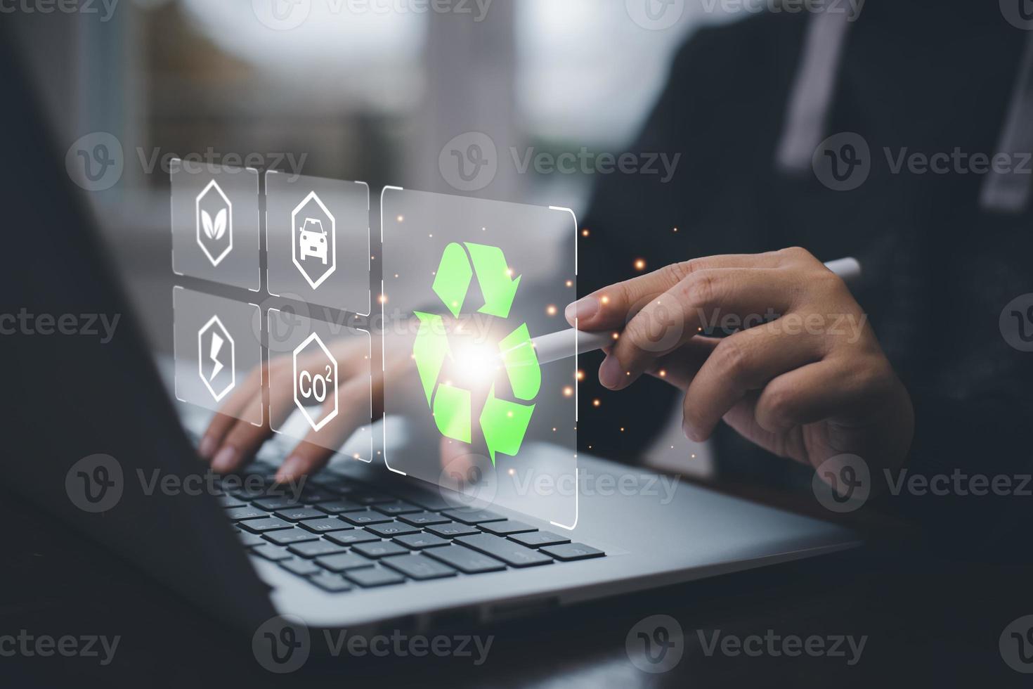 Businessman using laptops and touch recycle symbol with virtual modern reduce CO2 emission concept with icons, global warming emissions carbon footprint climate change to limit global warming, energy photo