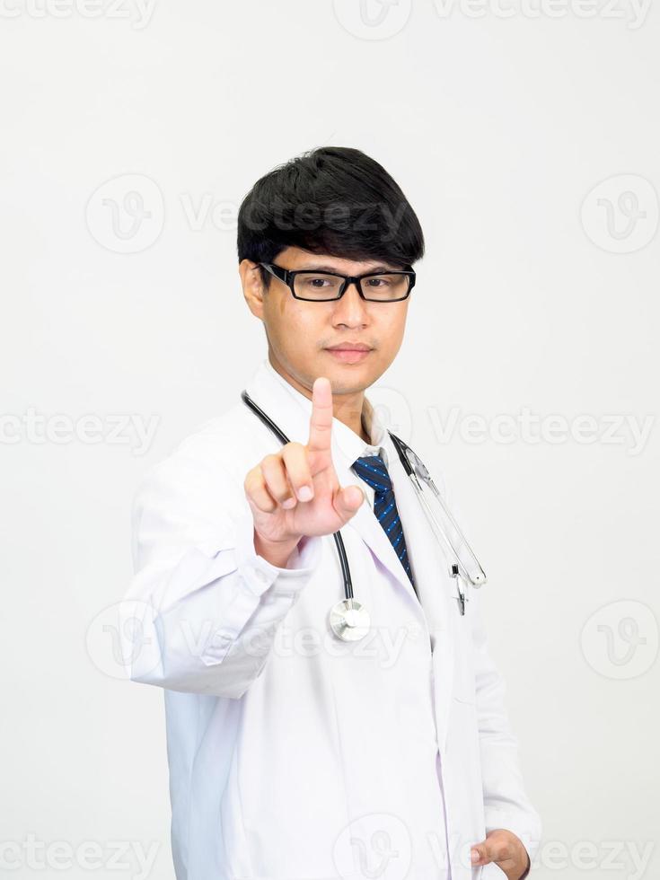 Asian man student scientist or doctor one person, wearing a white gown, standing, looking and smiling, white background with a stethoscope auscultating the heart around his neck. photo