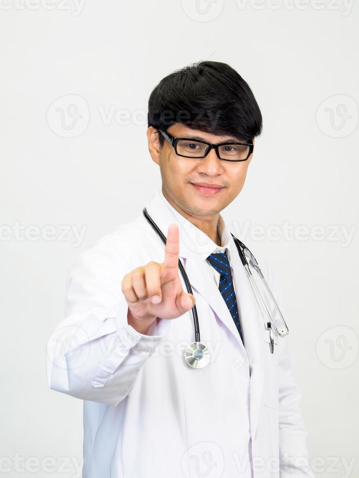 Asian man student scientist or doctor one person, wearing a white gown, standing, looking and smiling, white background with a stethoscope auscultating the heart around his neck. photo