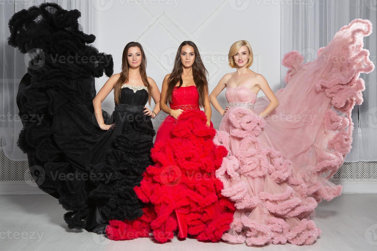 Three nice woman posing in the studio photo