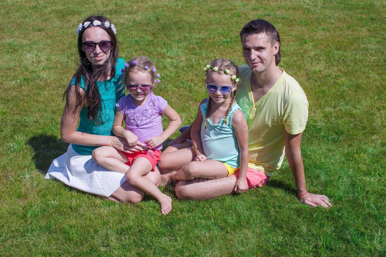 Happy family on the grass photo